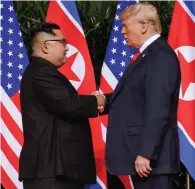  ?? Associated Press ?? ■ President Donald Trump shakes hands today with North Korea leader Kim Jong Un at the Capella resort on Sentosa Island in Singapore.