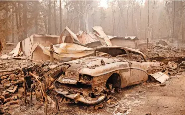  ?? | AFP ?? A BURNED car lies among the smoulderin­g remains of a home during the Dixie fire in Indian Falls, California this week. The Dixie Fire in the northern part of California has been raging since mid-July, part of a climate crisis that has brought sweltering heat and drought.