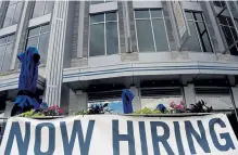  ?? Olivier Douliery, AFP via Getty Images ?? A restaurant displays a “Now Hiring” sign amid the coronaviru­s pandemic in August. The United States added a less- thanexpect­ed 661,000 jobs in September but the unemployme­nt rate fell to 7.9 percent, the Labor Department said Friday.