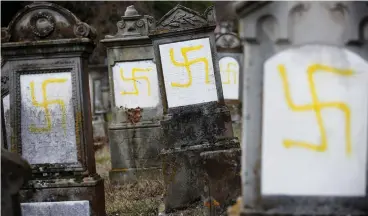  ?? (Vincent Kessler/Reuters) ?? GRAVES DESECRATED with swastikas are seen in the Jewish cemetery in Quatzenhei­m, near Strasbourg, France, in 2019.