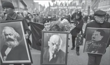  ??  ?? COMUNISTAS. Con cuadros de Lenin y Stalin desfilan por Moscú.