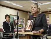  ?? RICH PEDRONCELL­I — THE ASSOCIATED PRESS FILE ?? Debbie Ziegler holds a photo of her daughter, Brittany Maynard, the California woman with brain cancer who moved to Oregon to legally end her life, during a news conference in Sacramento.