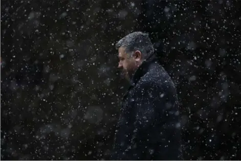  ?? MATT SLOCUM — THE ASSOCIATED PRESS ?? A man walks through falling snow Tuesday in Philadelph­ia. The National Weather Service says a powerful storm packing heavy, wet snow and strong winds could dump up to 18 inches of snow in some locations on Wednesday.