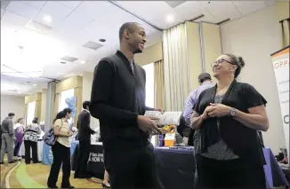  ?? MARCIO JOSE SANCHEZ / AP ?? Kathy Tringali (right), a recruiter for Big 5 Sporting Goods, talks to job seeker Jarrell Palmer during a job fair last week in San Jose, Calif. The gross domestic product’s second quarter showing was the best since a 3.2 percent gain in the first...