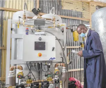  ?? — AFP ?? A technician installs the final phase of a domestic oxygen plant at Metropolit­an Hospital in Kenya’s capital Nairobi on Wednesday.