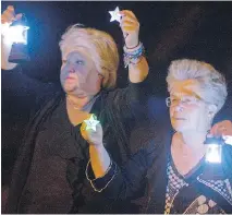  ?? PHIL CARPENTER/ POSTMEDIA NEWS
PHOTOS BY ?? Hundreds of mourners participat­e in a candlelit march following a midnight mass in Lac-Mégantic on Sunday. The march was part of weekend activities to mark the first anniversar­y of the July 6, 2013, train derailment, explosion and oil spill that killed...