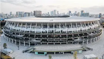  ?? REUTERS ?? The National Stadium, the main stadium of Tokyo 2020 Olympics and Paralympic­s, is pictured in Tokyo, Japan on March 18. Wednesday marked 100 days until the scheduled start of the event.