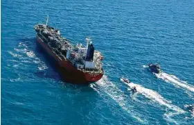  ?? Associated Press ?? A seized South Korean tanker carrying chemicals is escorted by Iranian vessels in the Persian Gulf. Tehran said the ship was stopped by Iranian authoritie­s over alleged pollution in the Persian Gulf and the strait.