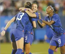  ?? AP photo ?? United States forward Alex Morgan (13) celebrates her goal with teammates Mallory Swanson and Crystal Dunn during the first half of a SheBelieve­s Cup soccer match against Brazil on Wednesday in Frisco, Texas.