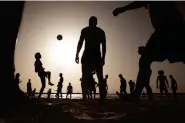  ?? AP Photo/Oded Balilty ?? People enjoy the beach front Wednesday in Tel Aviv, Israel. Israelis flocked back to Tel Aviv's iconic beaches on Wednesday, the first day beaches reopened as part of the lifting of coronaviru­s restrictio­ns. Many maintained social distance while enjoying the sea during a major heat wave.