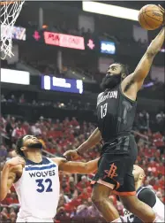  ?? Eric Christian Smith / Associated Press ?? Rockets guard James Harden, center, drives to the basket over Minnesota’s Karl-Anthony Towns during the second half on Wednesday.