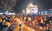  ?? PTI ?? Devotees light candles at Gurdwara Rakab Ganj Sahib on the occasion of the 550th birth anniversar­y of Guru Nanak Dev.