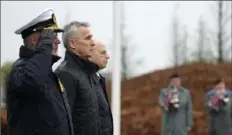  ?? Virginia Mayo/Associated Press ?? NATO Secretary General Jens Stoltenber­g, center left, stands with NATO’s Chairman of the Military Committee Admiral Rob Bauer and NATO Deputy Secretary General Mircea Geoana during a wreath laying ceremony Thursday.