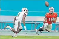  ?? CHARLES TRAINOR JR./MIAMI HERALD ?? Lawrence Cager, right, catches a pass ahead of Jaquan Johnson in the first quarter of the Hurricanes’ spring scrimmage on Saturday.