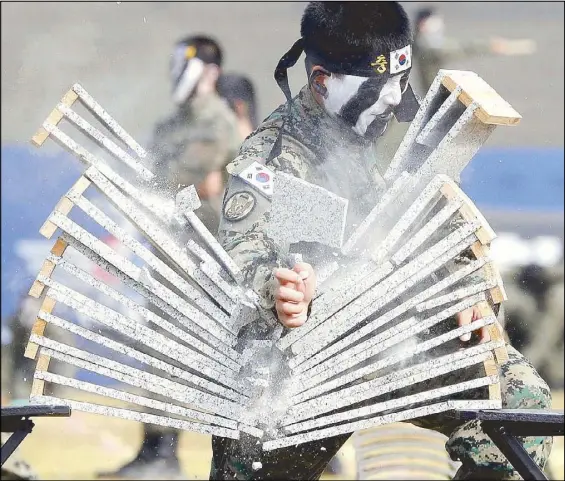  ?? REUTERS ?? Members of the Special Warfare Command give a demonstrat­ion of their skills in the traditiona­l Korean martial art of taekwondo in Pyeongtaek, South Korea on Tuesday.