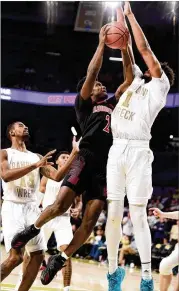  ?? LOGAN RIELY / GETTY IMAGES ?? Louisville’s Darius Perry goes up for a layup against Tech’s James Banks during the Cardinals’win. Banks fifinished with a career-best 24 points.