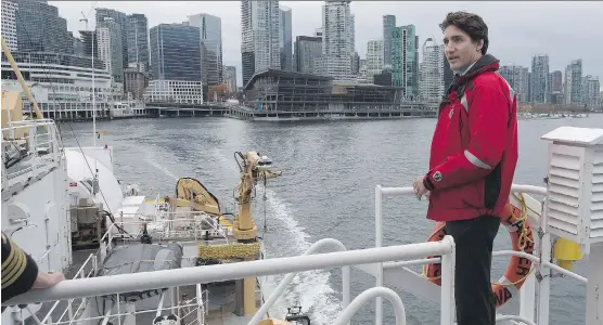  ?? THE CANADIAN PRESS ?? Prime Minister Justin Trudeau stands on board the Canadian Coast Guard ship Sir Wilfrid Laurier in Vancouver, where he unveiled new marine oil-shipping rules.