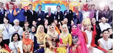  ??  ?? Christina and Koh (back row, seventh left and right) at the World Rotary Day Celebratio­n and IU Bazaar yesterday.