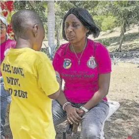  ??  ?? Head of the police Community Safety and Security Branch for the St James, Deputy Superinten­dent Yvonne Whyte-powell (right) attends to a participan­t during the four-week summer camp held in 2019 at the Salt Spring Primary and Infant School.