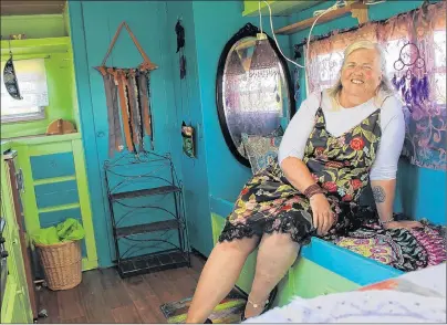  ?? MILLICENT MCKAY/JOURNAL PIONEER ?? Sue Woodworth sits in her gypsy vardo. Woodworth, a medium and energy healer, got the idea to build a genuine gypsy caravan in a way to travel with her work to community events.