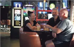  ?? CATHERINE RAFFERTY/THE REPUBLIC ?? Patrons hang out at The Rock in Phoenix on June 17. The Rock plans to air election night results on the gay bar’s TV screens.