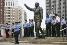  ?? MATT ROURKE, FILE - THE ASSOCIATED PRESS ?? In this 2017 photo, police officers guard a statue of former Philadelph­ia mayor and police commission­er Frank Rizzo on Thomas Paine Plaza outside the Municipal Services Building in Philadelph­ia. Mayor Jim Kenney told philly.com on Thursday, Aug. 9, the planned relocation of the Rizzo statue is being put on hold for at least two more years.