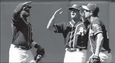  ?? ANDA CHU/TRIBUNE NEWS SERVICE ?? From left, the Oakland Athletics' Rajai Davis, Jaycob Brugman and Matt Joyce celebrate a 7-4 win against the Chicago White Sox in Oakland on Wednesday.