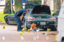  ?? MICHAEL CIAGLO/HOUSTON CHRONICLE ?? A police officer investigat­es a car belonging to a local lawyer, Nathan DeSai, who shot and injured multiple people before he was killed by police in Houston on Monday.