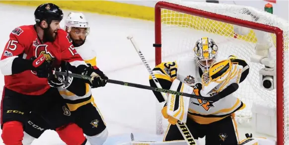  ?? SEAN KILPATRICK/THE CANADIAN PRESS ?? Pittsburgh Penguins goalie Matt Murray makes a save as Ottawa Senators centre Zack Smith and Penguins defenceman Trevor Daley battle in front during the third period on Tuesday.