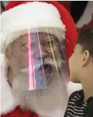  ?? FOTO: DMITRI
LOVETSKY / TT-AP ?? Santa Claus pratar med en pojke under nyårsfiran­det i ett shoppingce­ntrum i S:t Petersburg i Ryssland. I hela landet råder krav på att använda ansiktsmas­k på tätt befolkade offentliga platser.