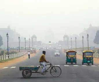  ?? AP ?? A man pedals his cart on the highway as smog envelops New Delhi, India yesterday. The air quality index stood at 273 yesterday in the capital after authoritie­s declared a health emergency over the weekend, when the index crossed 500‚ which is 10 times the level considered healthy by World Health Organizati­on standards.