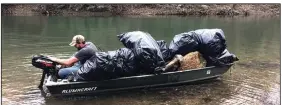  ?? (Special to the Democrat-Gazette/Michael and Tonya Sacomani) ?? The Sacomanis’ boat is loaded after a day of picking litter out of the Saline River.