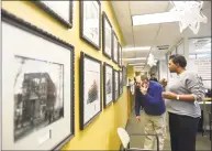  ??  ?? Folks look at historic town photograph­s during the open house at the City and Town Clerk’s Office in Stamford on Thursday.