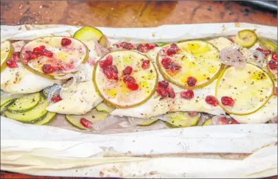  ?? AP PHOTO ?? Cod with zucchini and pomegranat­e, a recipe by Melissa d’Arabian, is a tasty way to work fish into a weekly meal plan.