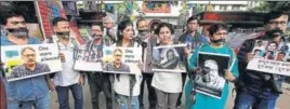  ?? REUTERS ?? Journalist­s hold placards during a silent protest against the killing of Shujaat Bukhari, the editorinch­ief of Rising Kashmir, who was shot dead by unidentifi­ed gunmen outside his office in Srinagar.