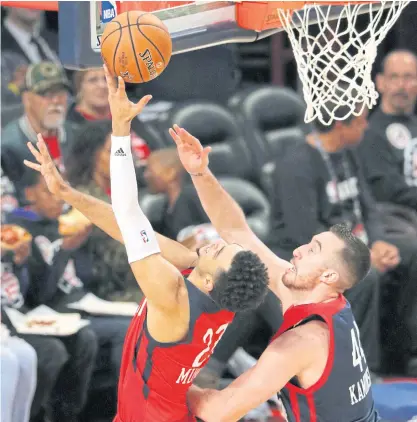  ??  ?? World Team’s Jamal Murray, left, goes to the basket against US Team’s Frank Kaminsky during the Rising Stars Challenge.