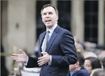  ?? JUSTIN TANG/THE CANADIAN PRESS ?? Finance Minister Bill Morneau is taking a wait-and-see-approach amid calls from business communitie­s to introduce measures in order to maintain their competitiv­eness with the U.S.