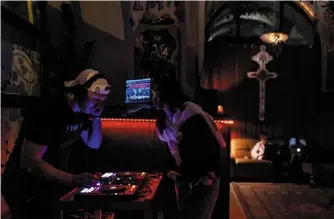  ?? ?? a dj playing inside the Karma bar in Warsaw, poland. — photos: afp