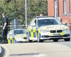  ??  ?? ●●Police at the scene where a man was knocked down by a car on Rochdale Road, Milnrow