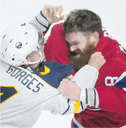  ?? GRAHAM HUGHES/THE CANADIAN PRESS ?? The Habs’ Jordie Benn and the Sabres’ Josh Gorges rough it up in the first period Saturday at the Bell Centre.