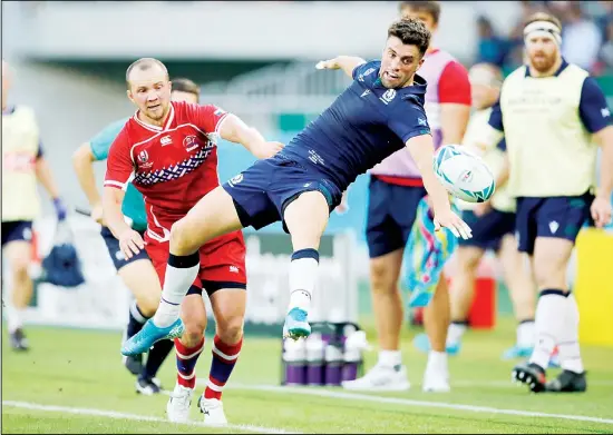  ??  ?? Scotland’s Adam Hastings reaches for the ball as Russia’s Ramil Gaisin, (left), watches during the Rugby World Cup Pool A game at Shizuoka Stadium Ecopa between Scotland and Russia in
Shizuoka, Japan on Oct 9. (AP)