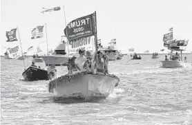  ?? PAUL W. GILLESPIE/BALTIMORE SUN MEDIA ?? Boats all decked out in flags make their way around Tangier Sound.