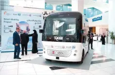  ?? ?? Visitors at the Mobility Education Summit in Abu Dhabi look ■ at a TXAI. Five such autonomous taxis transport passengers between nine pick up and drop off points on Yas Island.