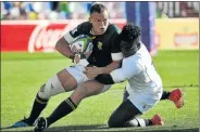  ?? Picture: WORLD RUGBY ?? TIED UP: South Africa’s Curwin Bosch is wrapped up by England winger Gabriel Ibitoye in their World Rugby U20 Championsh­ip semifinal yesterday