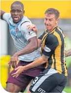 ??  ?? Chris Higgins up against Hearts’ Uche Ikpeazu during the group ties