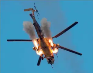  ?? Reuters ?? An Iraqi Air Force helicopter fires missiles at Daesh fighters near Mosul on Sunday. —
