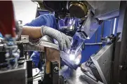  ?? CONTRIBUTE­D ?? An aerospace welder at work at GE Aviation/unison in Beavercree­k. Pre-pandemic, GE had about 1,600 total employees in the Dayton area.