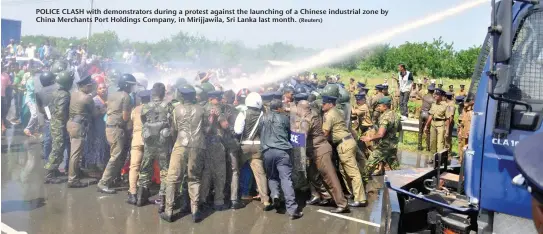  ?? (Reuters) ?? POLICE CLASH with demonstrat­ors during a protest against the launching of a Chinese industrial zone by China Merchants Port Holdings Company, in Mirijjawil­a, Sri Lanka last month.