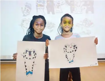  ??  ?? Two young participan­ts at the K-Culure Day, held Thursday at the Korean Cultural Centre Abuja hold up their finished drawings of the mascots for the Pyeongchan­g Winter Olympics. Attendees were given the opportunit­y to draw the mascots which will later...