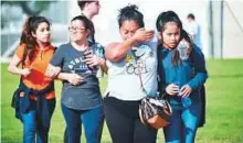  ?? AFP ?? Parents pick up their children at Salvadore Castro Middle School in Los Angeles, California on Thursday. Two students were shot and wounded in class at the school.